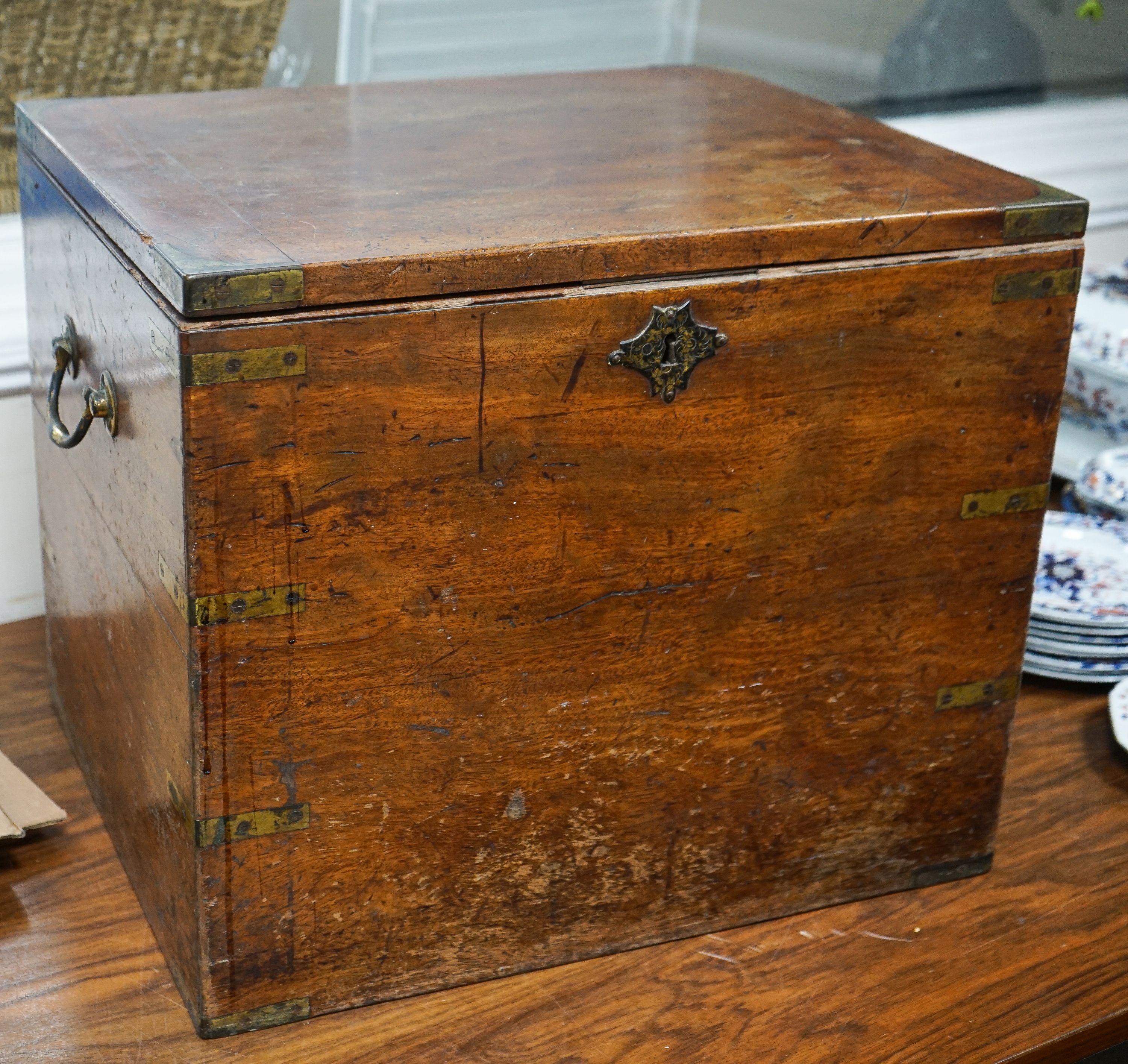 A 19th century brass-bound teak campaign trunk, having hinged top and side mounted carrying handles, width 55cm, depth 43cm, height 44cm